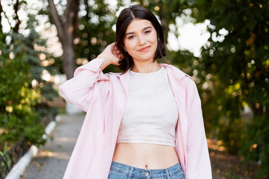 Young woman smiling while posing in a park