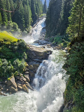 Krimmler waterfall in the forest, alps mountains austria