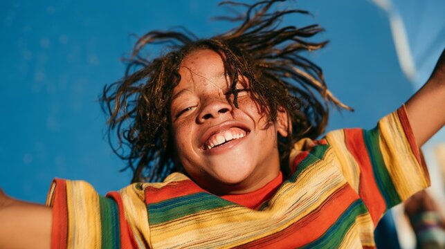Joyful Child in Colorful Attire, Smiling and Raising Arms