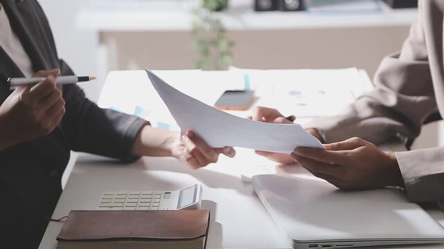 Business partnership coworkers using a tablet to analysis graph company financial budget report and cost work progress and planning for future in office room.