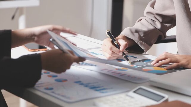 Business partnership coworkers using a tablet to analysis graph company financial budget report and cost work progress and planning for future in office room.