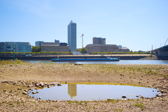 Low stream gauge of rhine river in D&uuml;sseldorf, Germany.Due to drought, climate change and global warming ships can only operate with reduced cargo.