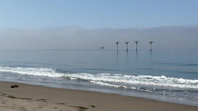 Scenic vista of old piling relics off the Pacific coast in Goleta, Santa Barbara County, Southern California	