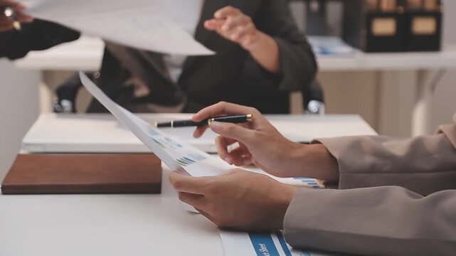 Business partnership coworkers using a tablet to analysis graph company financial budget report and cost work progress and planning for future in office room.