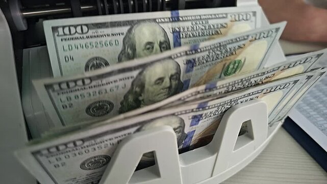 Counting money with a cash counting machine in a business office setting