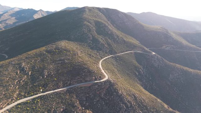 Aerial of winding dirt road mountain pass, Swartberg pass, South Africa