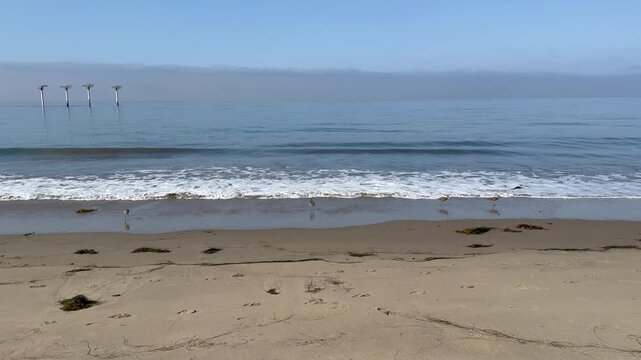 Scenic vista of old piling relics off the Pacific coast in Goleta, Santa Barbara County, Southern California	