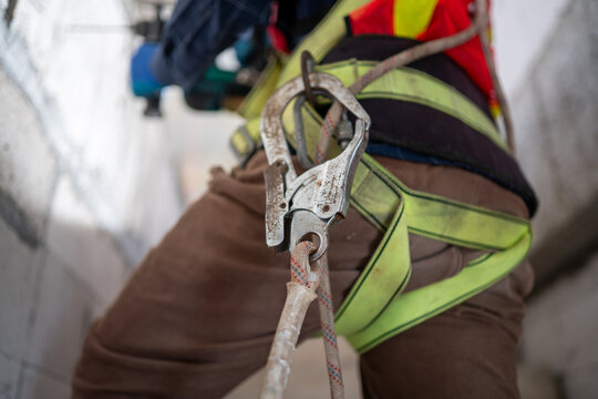 Worker Wearing Safety Harness and Rope Protection Equipment During Height Work