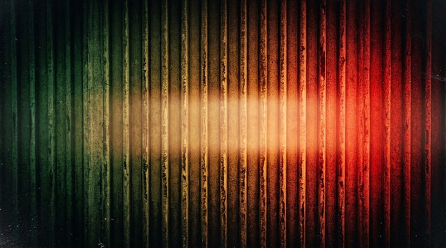 Abstract vertical stripe background with green yellow and red color gradient. Dark textured ribbed pattern with soft light glow. Modern geometric backdrop for creative digital design projects.
