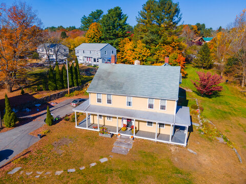 Historic colonial style house aerial view at 8 Main Street at Old Douglas Town Common in fall with foliage in historic town center of Douglas, Massachusetts MA, USA. 