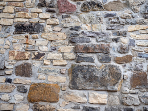 Detail of an old stone wall at Vysehrad in Prague, Czech Republic, showing irregular natural stones, historic masonry and weathered texture.