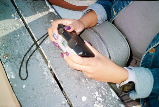 Woman's hands holding a camera