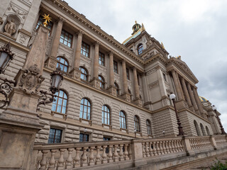 Fototapeta premium Side view of the historic National Museum in Prague, Czech Republic, featuring grand Neo-Renaissance architecture, columns, ornate facade and decorative details.