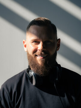 Man With Headphones Smiles in Sunlight