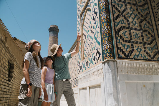 Father showing his daughters historic geometric tilework