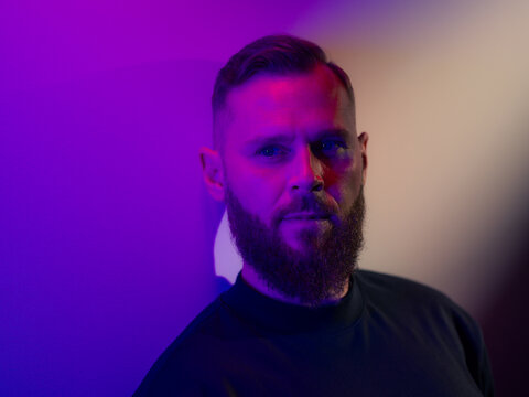 Man portrait in purple light
