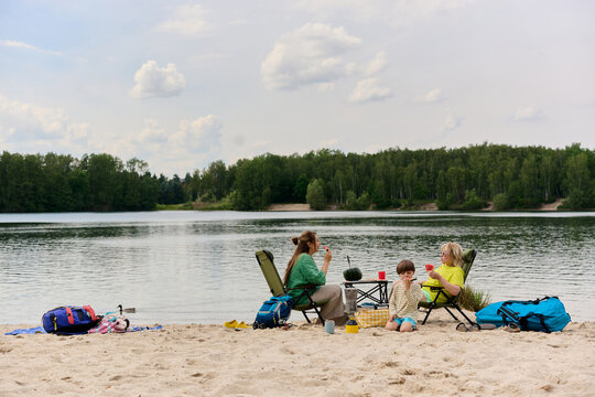 Family Picnic with Watermelon by the Lake