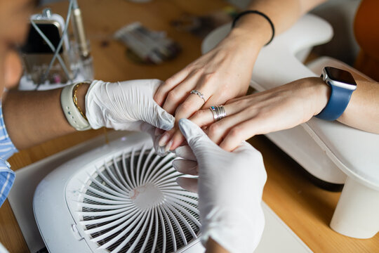 Close-up of nail shaping with a dust collector