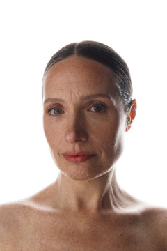 Woman with her hair tied back and natural makeup in a studio