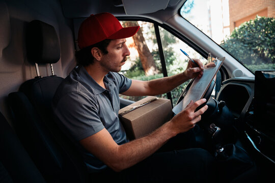 Delivery driver checking packages before delivery
