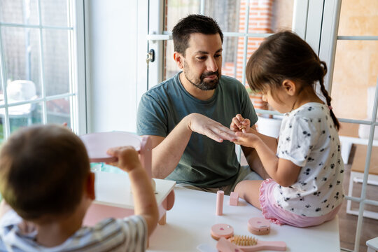 Girl Giving Father Pretend Manicure