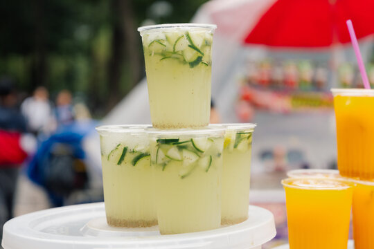 Fresh cucumber drink cups at market