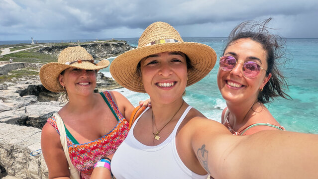 Happy women taking selfie enjoying Caribbean vacation