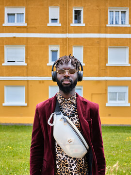 Stylish man with headphones and leopard print shirt
