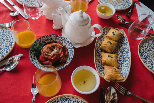 Traditional Central Asian meal with baked samsa and tea.