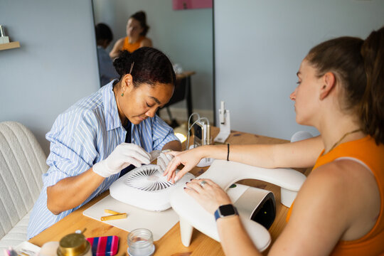 Professional manicure using a hand nail file