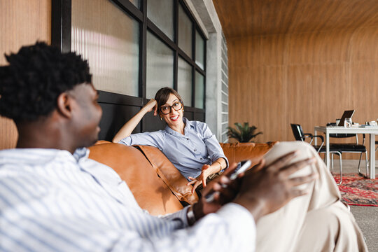 People Talk in a Modern Office Lounge During Work Hours