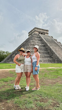 Women friends traveling Chichen Itza ancient Mayan ruins