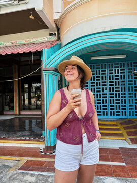 Woman enjoying a refreshing iced coffee during Mexico trip