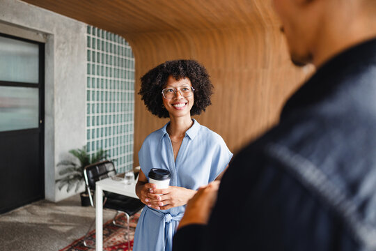 Meeting in a Modern Space With a Woman Holding a Coffee Cup