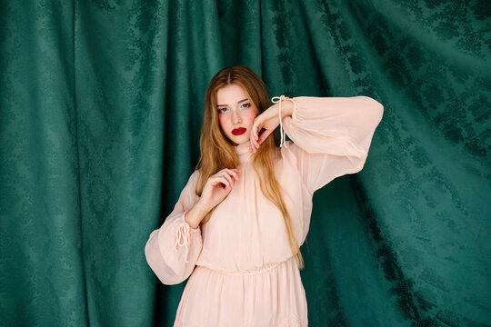 Woman posing in light pink dress 