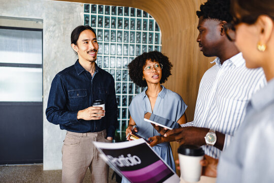 Team Members Discuss Project Ideas in Modern Office Space