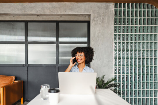 Working Woman on a Phone Call in a Modern Office Setting