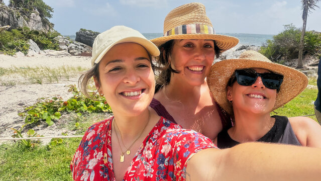 Happy women enjoying vacation and taking selfie in Mexico