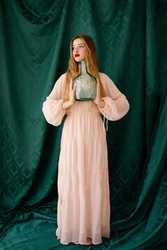 Woman holding vintage glass bottle 