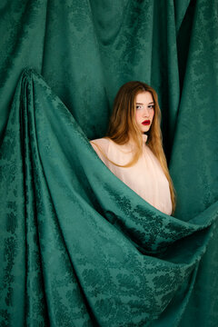 Woman emerging from fabric