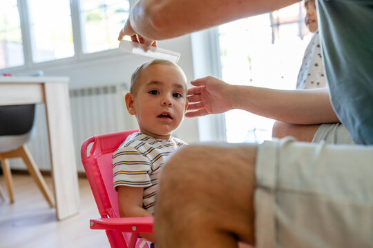 Toddler Getting Hair Combed Indoors