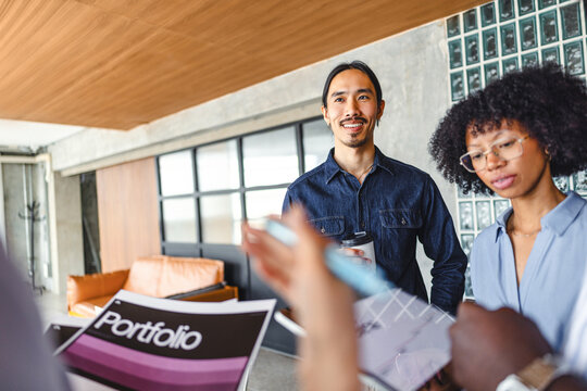 Meeting About Portfolio Ideas in Modern Office Setting