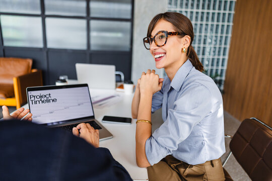 Discussion About Project Timeline in Modern Office Setting