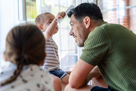 Boy Styling His Father's Hair