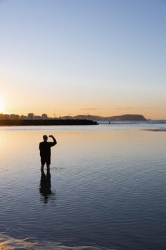 Taking a photo of the sunset on the river in the Gold Coast 
