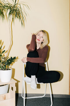 A woman sitting on a chair.
