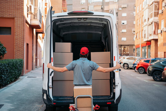 Delivery worker unloading packages from delivery van