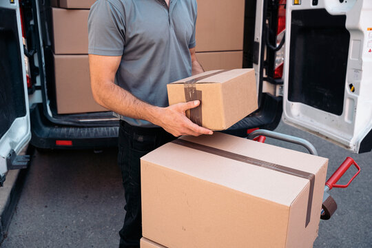 Delivery service man handling packages for shipping