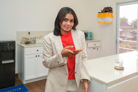 Smiling businesswoman using smartphone at work