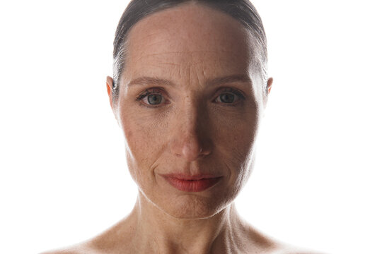 Woman With Gray Hair Stands in Front of a Bright Background